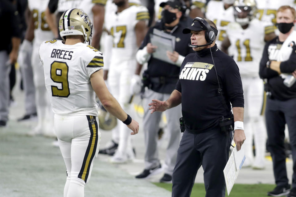 New Orleans Saints head coach Sean Payton speaks with quarterback Drew Brees (9) during the first half of an NFL football game against the Las Vegas Raiders, Monday, Sept. 21, 2020, in Las Vegas. (AP Photo/Isaac Brekken)