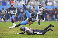 Tennessee Titans wide receiver Nick Westbrook-Ikhine (15) is brought down by Houston Texans cornerback Desmond King (25) in the second half of an NFL football game Sunday, Nov. 21, 2021, in Nashville, Tenn. (AP Photo/Mark Zaleski)