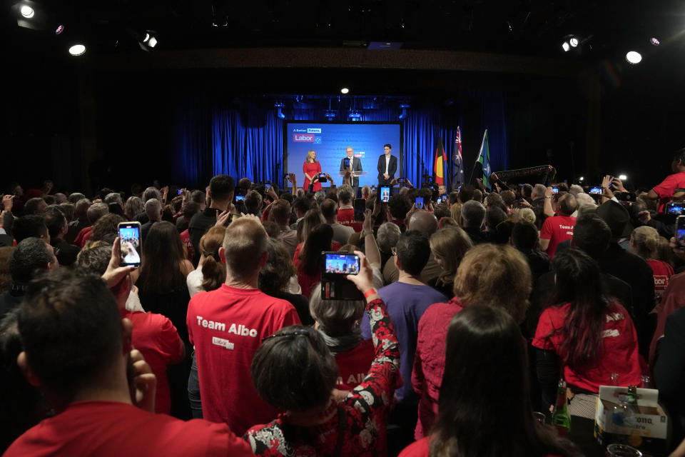 Labor Party leader Anthony Albanese, center back, speaks to supporters at a Labor Party event in Sydney, Australia, Sunday, May 22, 2022, after Prime Minister Scott Morrison conceding defeat to Albanese in a federal election. (AP Photo/Rick Rycroft)