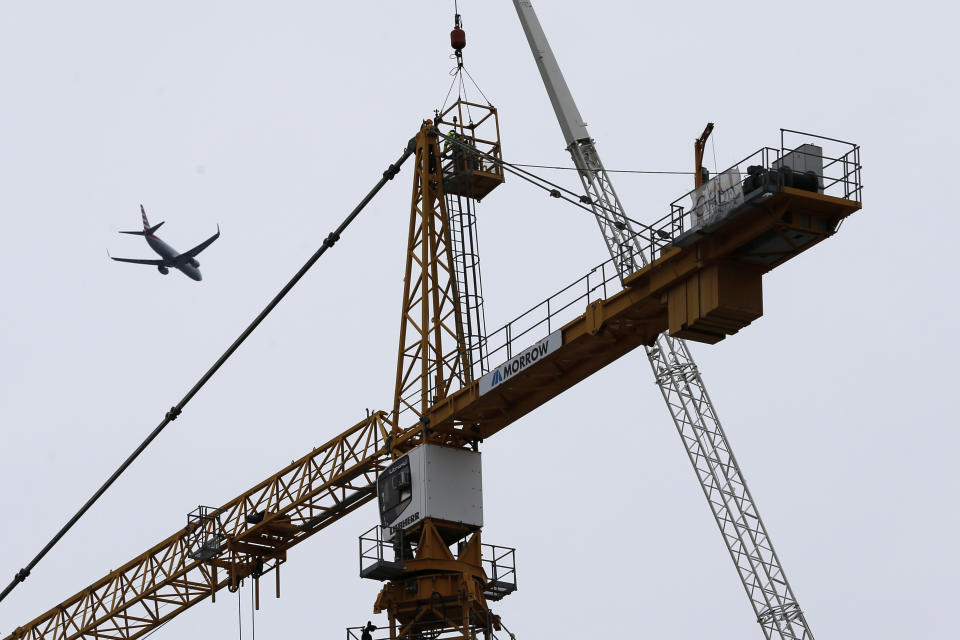 Workers in a bucket begin the process of planting explosive charges on two unstable cranes at the Hard Rock Hotel, which underwent a partial, major collapse on Saturday, Oct. 12, in New Orleans, viewed Thursday, Oct. 17, 2019. Authorities say explosives will be strategically placed on the two unstable construction cranes in hopes of bringing them down with a series of small controlled blasts ahead of approaching tropical weather. Officials hope to bring the towers down Friday without damaging nearby businesses and historic buildings in and around the nearby French Quarter. (AP Photo/Gerald Herbert)