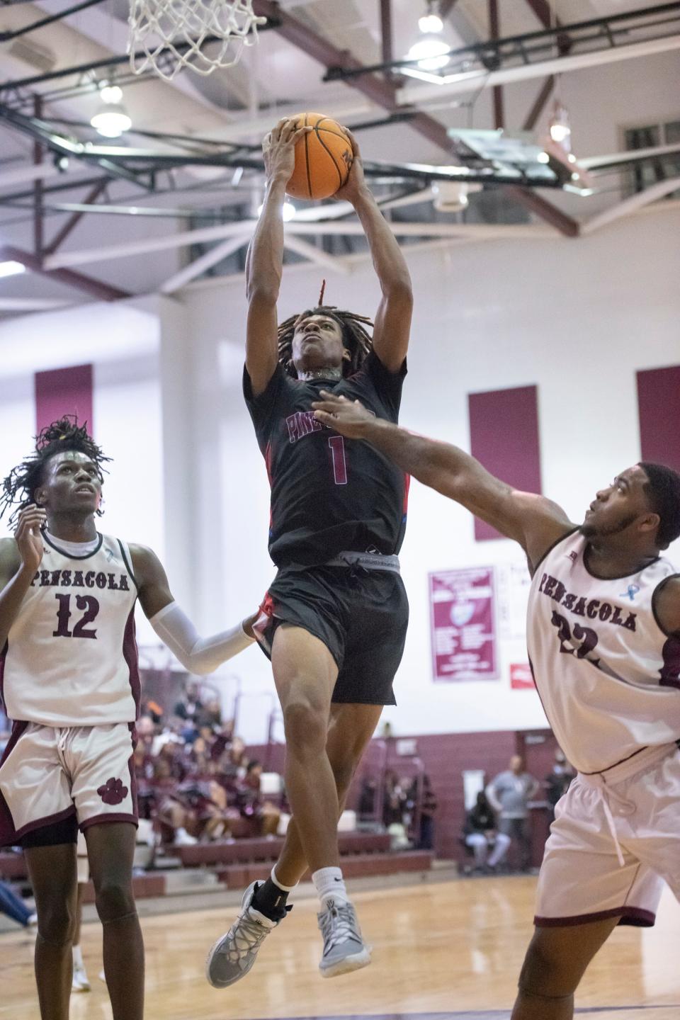 Omarayon Turner (1) takes it to the hoop during the Pine Forest vs PHS boys basketball game at Pensacola High School on Friday, Jan. 14, 2022.