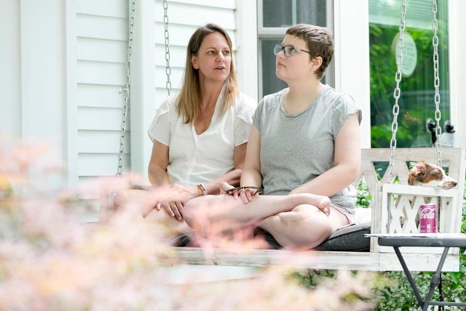 Alea Ramsey, 18, right, sits with her mother Janette Ramsey and dachshund Fiona at their family home in Upper Arlington. Alea Ramsey has turned five years of battling recurring osteosarcoma cancer into advocacy for childhood cancer research. In June, she also published a book highlighting her experiences with the aggressive cancer.