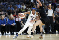 Minnesota Lynx guard Moriah Jefferson (4) drives past Las Vegas Aces forward Dearica Hamby during a WNBA basketball game in Las Vegas on Thursday, May 19, 2022. (Steve Marcus/Las Vegas Sun via AP)