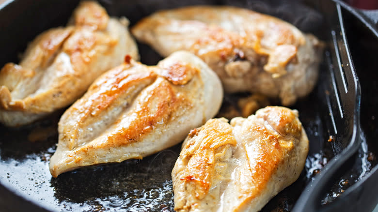 chicken cooking in frying pan