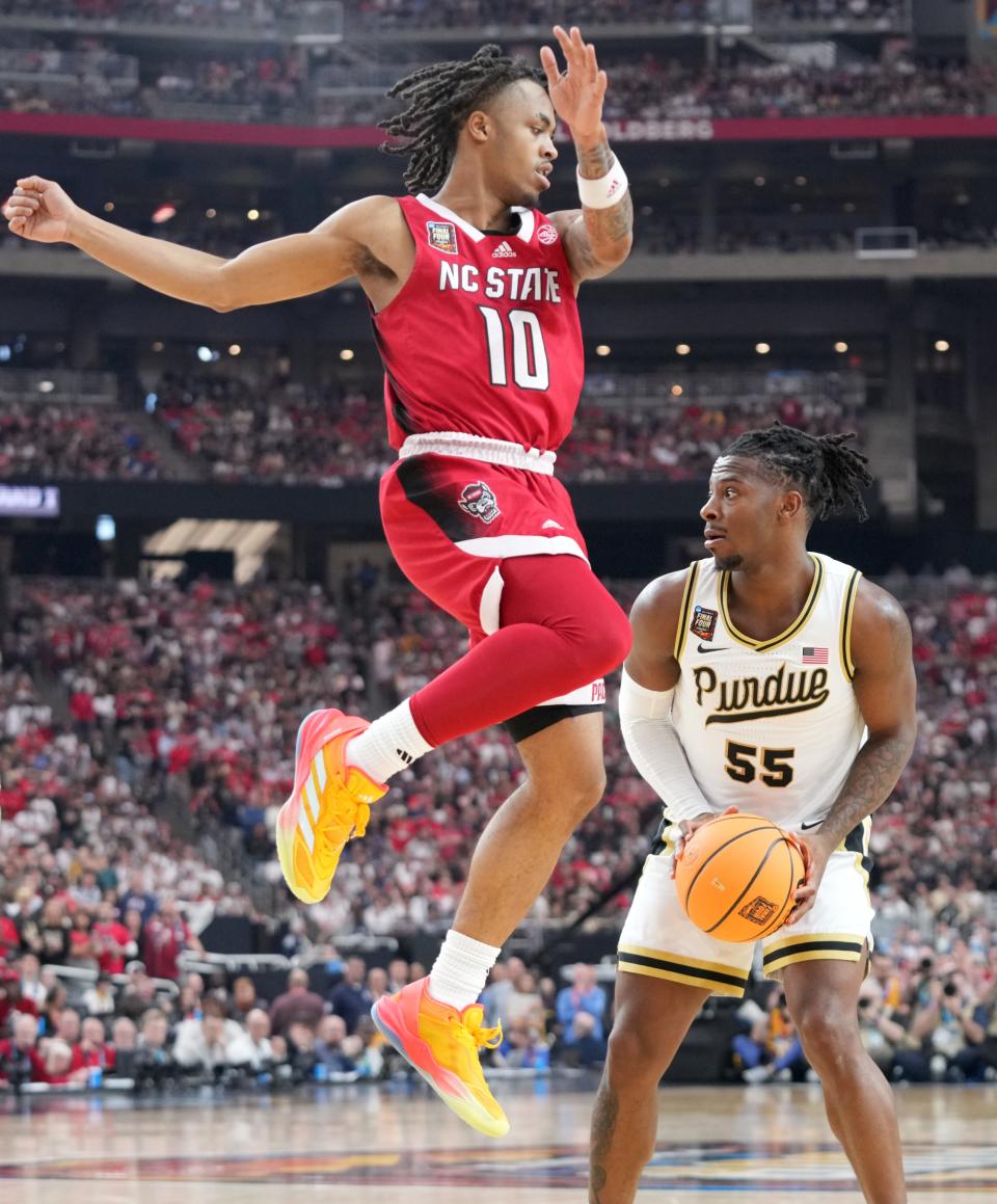 North Carolina State Wolfpack guard Breon Pass (10) jumps to defend the shot of Purdue Boilermakers guard Lance Jones (55) during the NCAA Men’s Basketball Tournament Final Four game, Saturday, April 6, 2024, at State Farm Stadium in Glendale, Ariz.