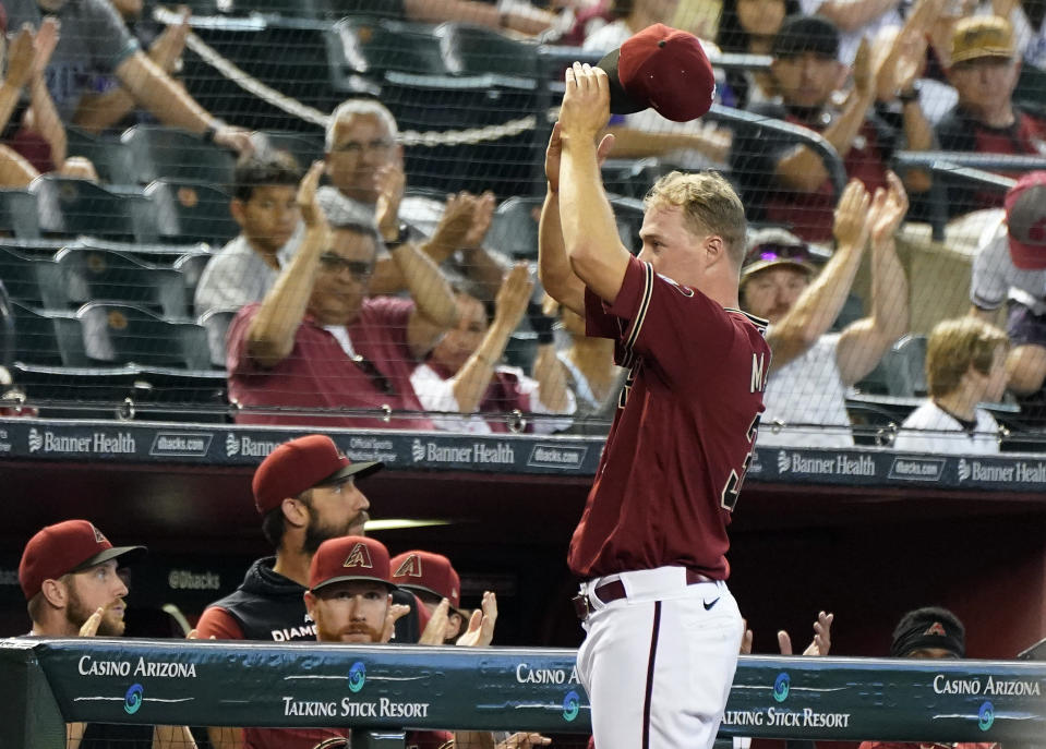 After it was announced that he made the All-Star game, Arizona Diamondbacks pitcher Joe Mantiply tips his hat to the crowd during the eighth inning of their baseball game with the Colorado Rockies, Sunday July 10, 2022, in Phoenix. (AP Photo/Darryl Webb)