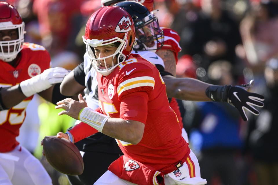 Kansas City Chiefs quarterback Patrick Mahomes (15) escapes the grasp of Jacksonville Jaguars linebacker Travon Walker (44) during the first half of an NFL football game, Sunday, Nov. 13, 2022 in Kansas City, Mo. (AP Photo/Reed Hoffmann)