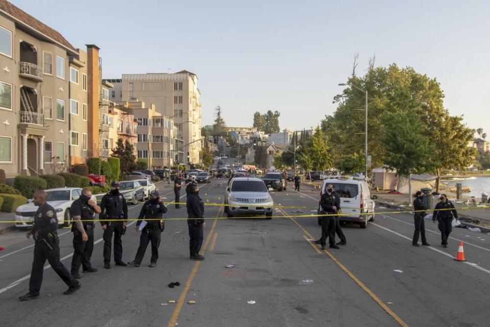 Police officers on the scene at Lake Merritt in Oakland, following a shooting on 19 July.