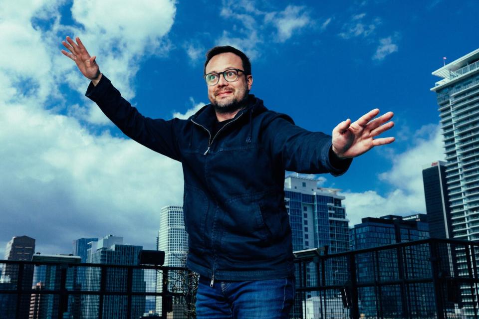 Meow Wolf's Sean Di Ianni in front of the downtown Los Angeles skyline.