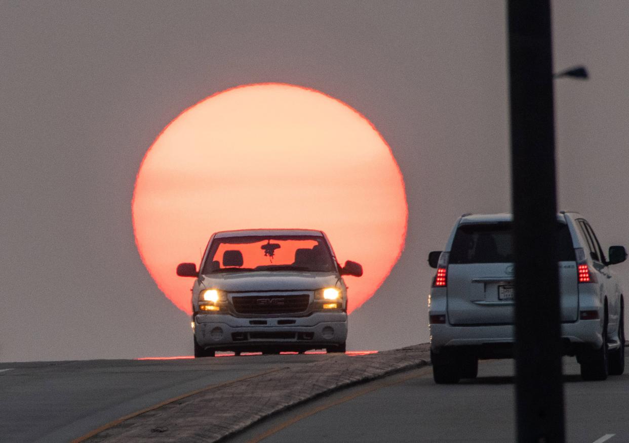 Traffic crests the Rowan Street bridge just before sunset in Fayetteville on July 22, 2021. Sunset is at 7:44 p.m. Sept. 1 but changes to 6:54 p.m. Sept. 30. September's earlier sunsets and later sunrises result in the loss of an hour of daylight during the month.