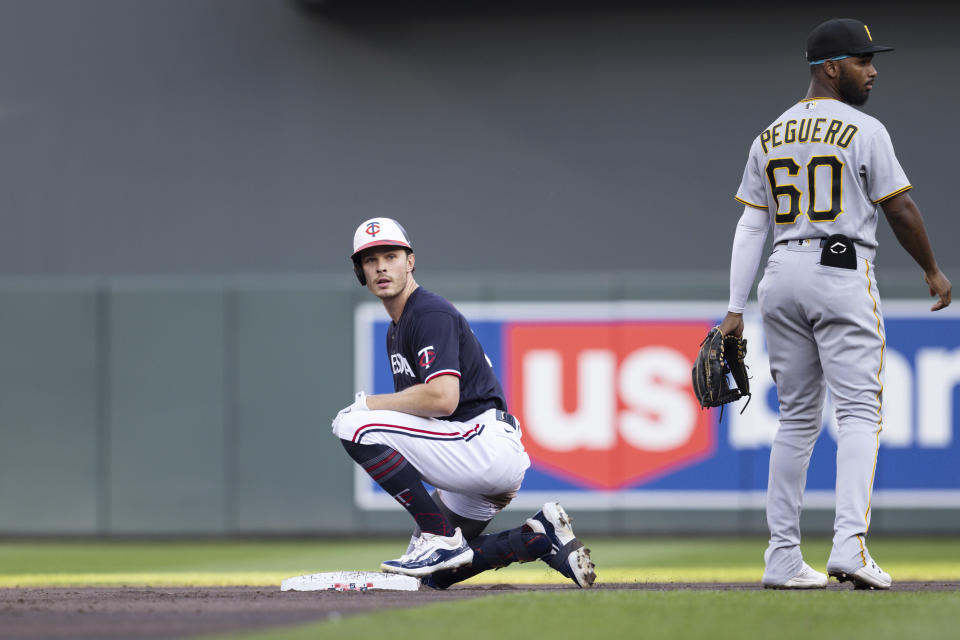 Minnesota Twins' Max Kepler kneels on second base after hitting an RBI double off of Pittsburgh Pirates starting pitcher Mitch Keller during the first inning of a baseball game Saturday, Aug. 19, 2023, in Minneapolis. (AP Photo/Bailey Hillesheim)