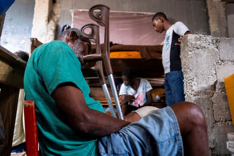 People shelter inside a school after their settlement was burned down by gangs, in Port-au-Prince