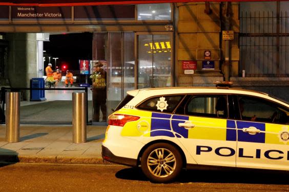 Police officers stand at the end of a tram platform following the stabbing (Reuters)