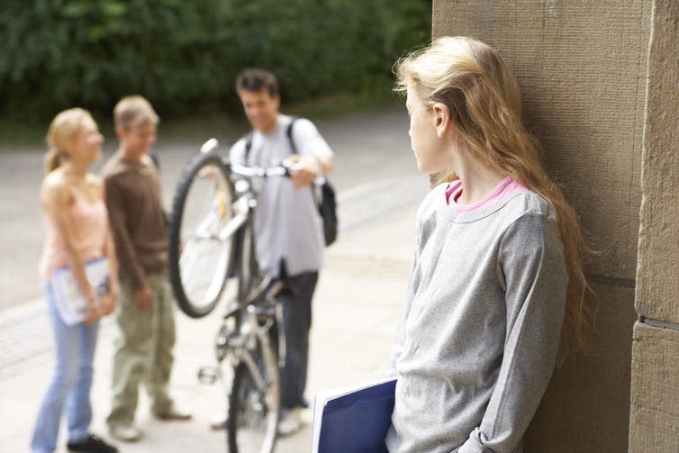<span class="caption">For some children and young people, the summer holidays can be a time of loneliness.</span> <span class="attribution"><a class="link " href="https://www.shutterstock.com/image-photo/group-friends-chat-while-girl-looks-216778345" rel="nofollow noopener" target="_blank" data-ylk="slk:Air Images/Shutterstock;elm:context_link;itc:0;sec:content-canvas">Air Images/Shutterstock</a></span>