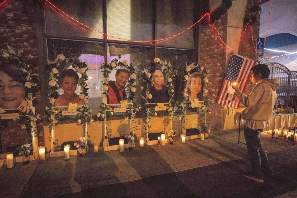 Eric Sham visits a makeshift memorial on Tuesday, Jan. 24, 2023 for those killed in a mass shooting at The Star Ballroom Dance Studio in Monterey Park. (Sarah Reingewirtz/The Orange County Register via AP)