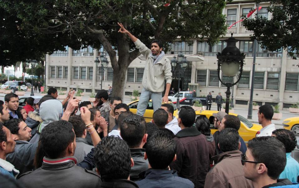 A man addresses to demonstrators during a protest in Tunis, to protest police violence in Tunisian town of Siliana Thursday, Nov. 29, 2012. Tunisia's army intervened Thursday in a third day of violent clashes in a northern town between police and striking residents who are demanding jobs and investment. After two days of battles that a hospital said left more than 300 people injured, police pulled out of Siliana Wednesday night. Witnesses said 15,000 people marched through the town Thursday demanding the governor's resignation. (AP Photo/Amine Landoulsi)