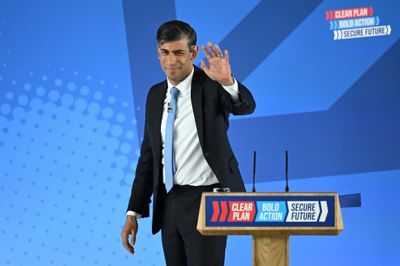 Prime minister Rishi Sunak waves after speaking at the Conservative Party's general election manifesto launch at Silverstone Circuit