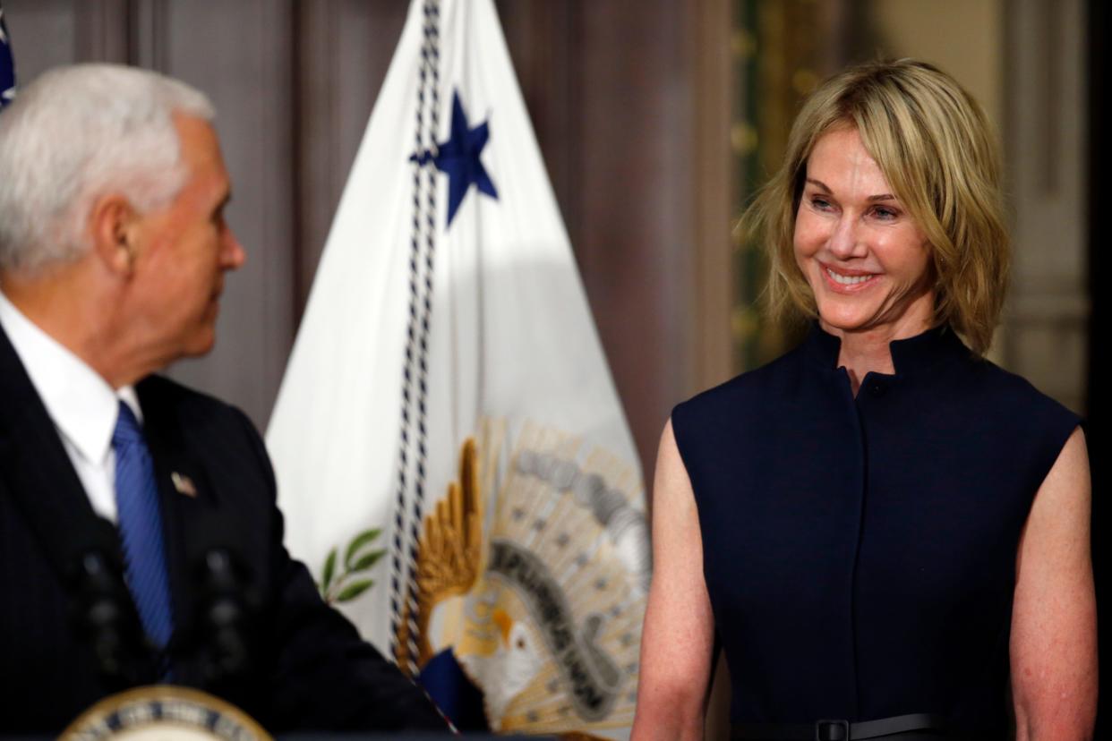 Vice President Mike Pence turns to speak to Kelly Knight Craft, during her swearing in ceremony to be U.S. Ambassador to Canada, in the Indian Treaty Room in the Eisenhower Executive Office Building on the White House grounds, Tuesday, Sept. 26, 2017, in Washington. (AP Photo/Alex Brandon)