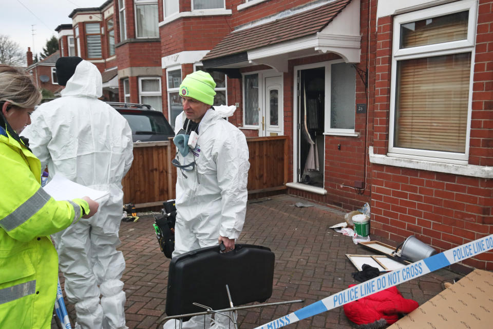 Forensics officers at the scene of a fire at a house on Wensley Avenue, Hull, where two people have died, including an eight-year-old.