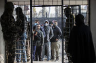 Kashmiris wait in a queue to cast their votes during the first phase of District Development Councils election on the outskirts of Srinagar, Indian controlled Kashmir, Saturday, Nov. 28, 2020. Thousands of people in Indian-controlled Kashmir voted Saturday amid tight security and freezing cold temperatures in the first phase of local elections, the first since New Delhi revoked the disputed region's semiautonomous status. (AP Photo/Mukhtar Khan)