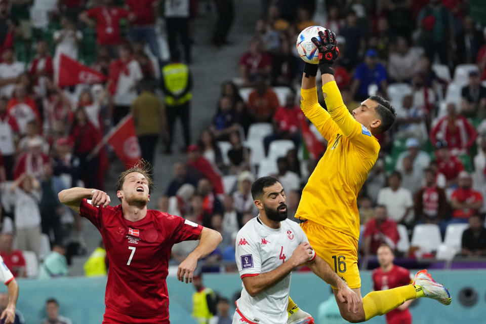 Tunisia's goalkeeper Aymen Dahmen saves a ball during the World Cup group D soccer match between Denmark and Tunisia, at the Education City Stadium in Al Rayyan , Qatar, Tuesday, Nov. 22, 2022. (AP Photo/Petr David Josek)