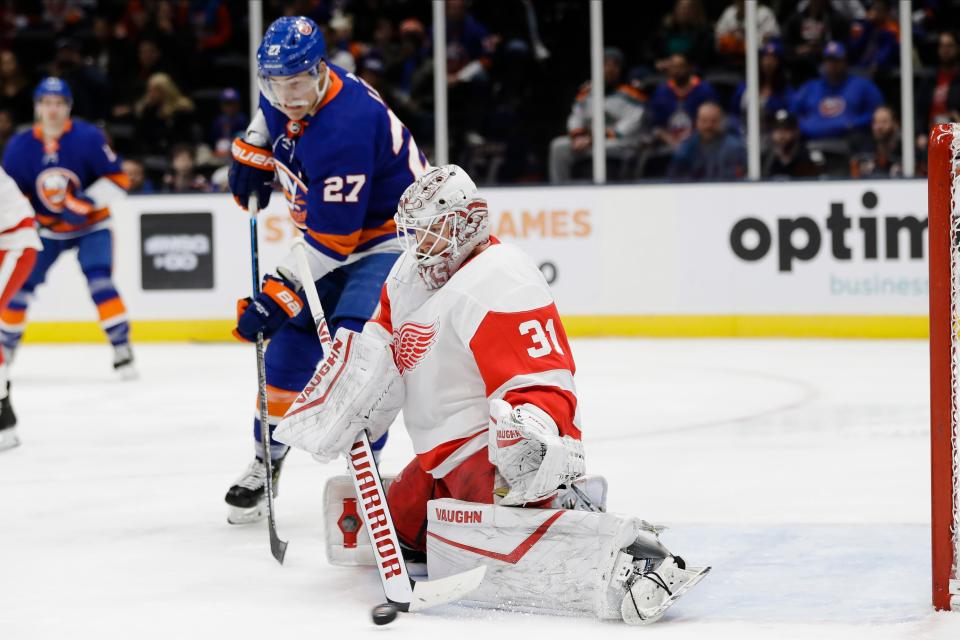 Detroit Red Wings goaltender Calvin Pickard (31) stops a shot on goal as New York Islanders' Anders Lee (27) watches during the second period of an NHL hockey game Tuesday, Jan. 14, 2020, in Uniondale, N.Y. (AP Photo/Frank Franklin II)