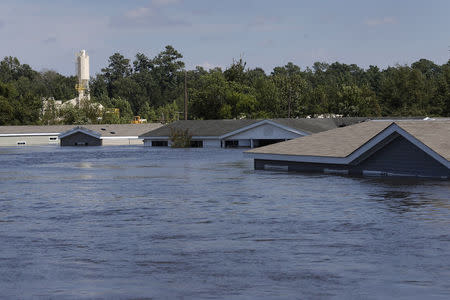 Submerged houses are seen by flood waters from Tropical Storm Harvey in Rose City, Texas, U.S., on August 31, 2017. REUTERS/Jonathan Bachman