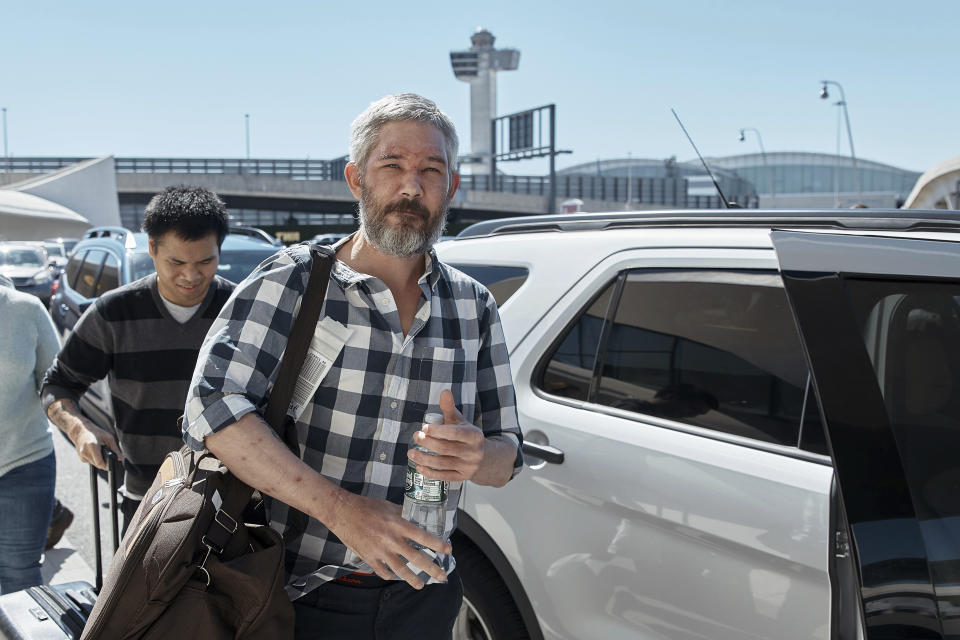 American's Andy Huynh, left, and Alex Drueke, center, arrive at the TWA Hotel on Friday, Sept. 23, 2022 in New York. The two U.S. military veterans who disappeared three months ago while fighting Russia with Ukrainian forces were among 10 prisoners, including five British nationals, released this week by Russian-backed separatists as part of a prisoner exchange mediated by Saudi Arabia. (AP Photo/Andres Kudacki)