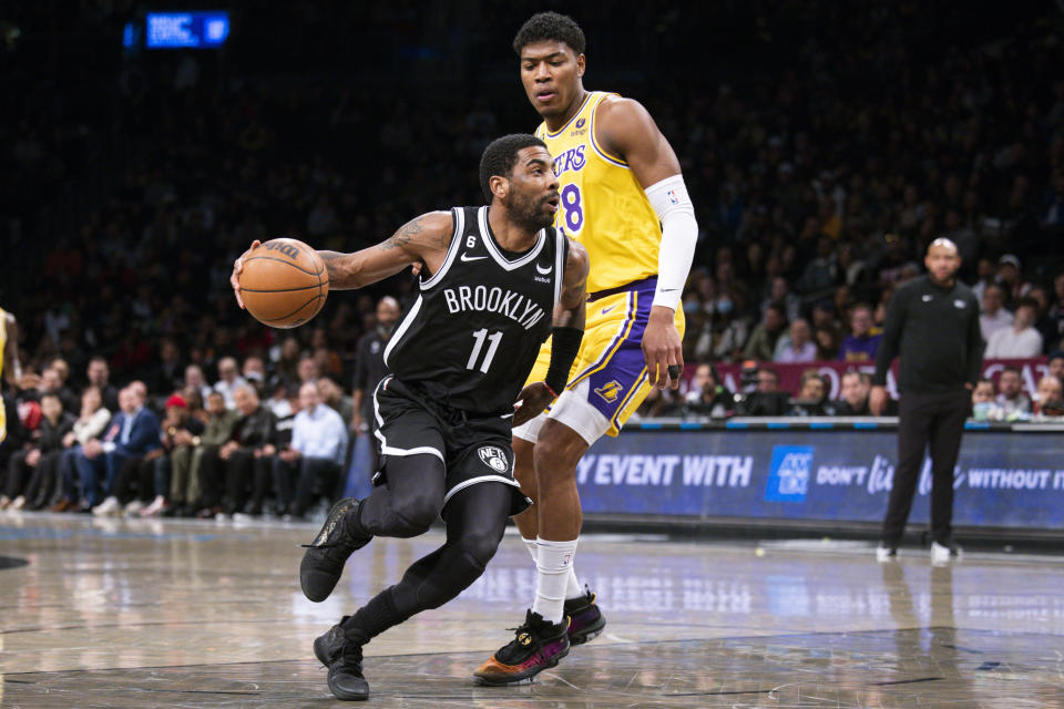 Brooklyn Nets guard Kyrie Irving (11) drives past Los Angeles Lakers forward Rui Hachimura (28) during the first half of an NBA basketball game Monday, Jan. 30, 2023, in New York. (AP Photo/Corey Sipkin)