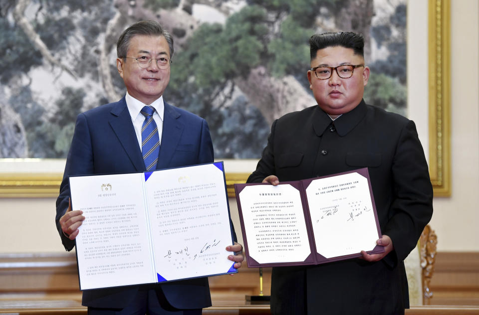 FILE - In this Sept. 19, 2018, file photo, South Korean President Moon Jae-in, left, and North Korean leader Kim Jong Un hold documents after signing at the Paekhwawon State Guesthouse in Pyongyang, North Korea. Moon and Kim held the first of their summit talks Tuesday, Sept. 18, at the Pyongyang headquarters of the ruling Workers’ Party. It’s where Kim’s office is located and South Korean media dub it “the heart of North Korea.” (Pyongyang Press Corps Pool via AP, File)