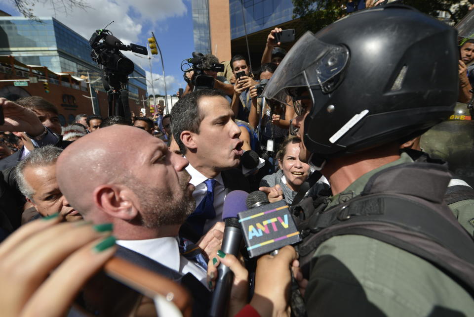 Opposition leader Juan Guaido argues for National Guards to let him and all opposition lawmakers into the National Assembly, outside the legislature in Caracas, Venezuela, Tuesday, Jan. 7, 2020. Venezuela’s opposition is facing its biggest test yet after government-backed lawmakers announced they were taking control of what Guaidó supporters have described as the nation’s last democratic institution. (AP Photo/Matias Delacroix)