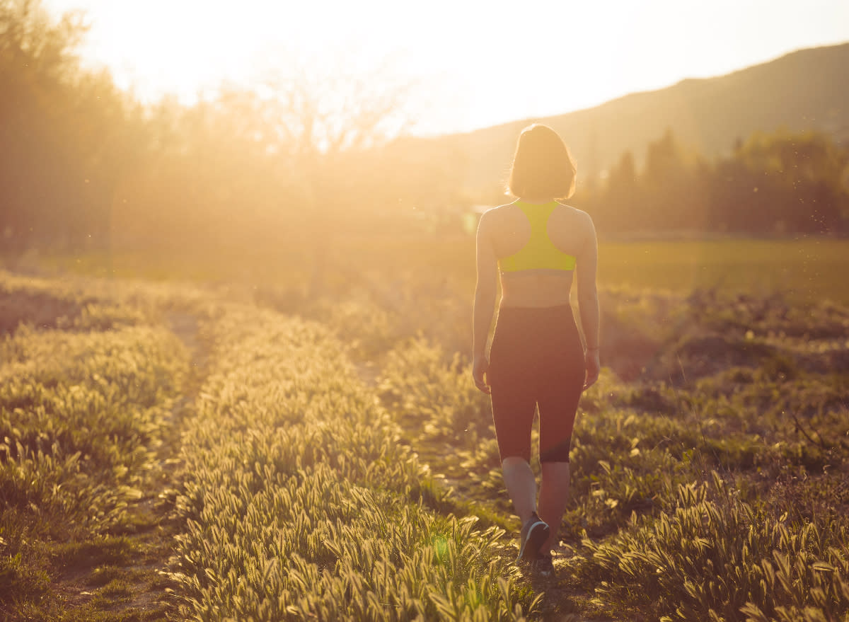 woman walking in the sunshine, concept of how many steps to take to live longer