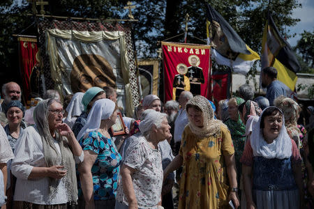 Local churchgoers attend a procession organised by the Union of Orthodox Banner-Bearers to commemorate 100 years since the killing of Tsar Nicholas II, in Spaso-Andronikov Monastery in Moscow, Russia, July 17, 2018. REUTERS/Ekaterina Anchevskaya