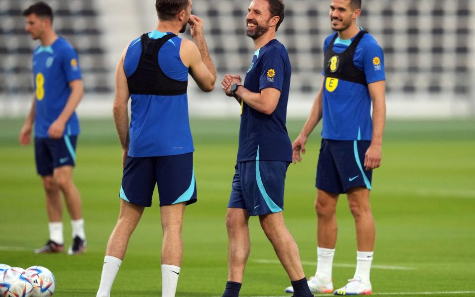 England's Jordan Henderson shares a joke with manager Gareth Southgate and Conor Coady during a training session at the Al Wakrah Sports Club - Martin Rickett/PA Wire