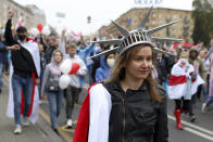 A woman wearing a crown similar to the one on the American statue of Liberty, during an opposition rally to protest the official presidential election results in Minsk, Belarus, Sunday, Sept. 27, 2020. Tens of thousands of demonstrators marched in the Belarusian capital calling for the authoritarian president's ouster, some wearing cardboard crowns to ridicule him, on Sunday as the protests that have rocked the country marked their 50th consecutive day. (AP Photo/TUT.by)