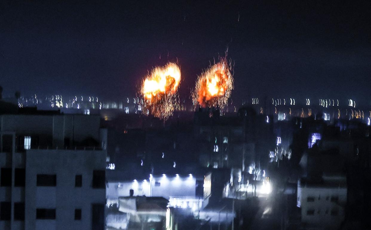 Explosions lit up the night sky about building in Gaza city as Israeli forces shelled the Palestinian enclave, in response to incendiary balloons. (AFP/Getty)