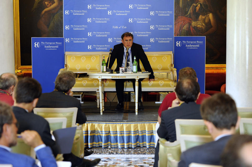 U.S. economist Nouriel Roubini, center, speaks during a meeting on the world economy in Cernobbio, Italy, Friday, Sept. 7, 2012. Experts and leaders gathered in Italy to discuss the global financial crisis. (AP Photo/Giuseppe Aresu)