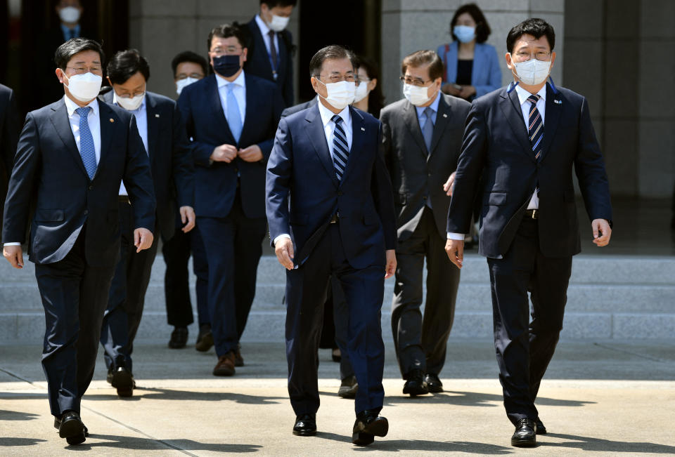 South Korean President Moon Jae-in (C) walks with officials as he leaves for the United States at Seoul Air Base in Seongnam, south of Seoul, on May 19, 2021. (Photo by Jung Yeon-je / AFP) (Photo by JUNG YEON-JE/AFP via Getty Images)