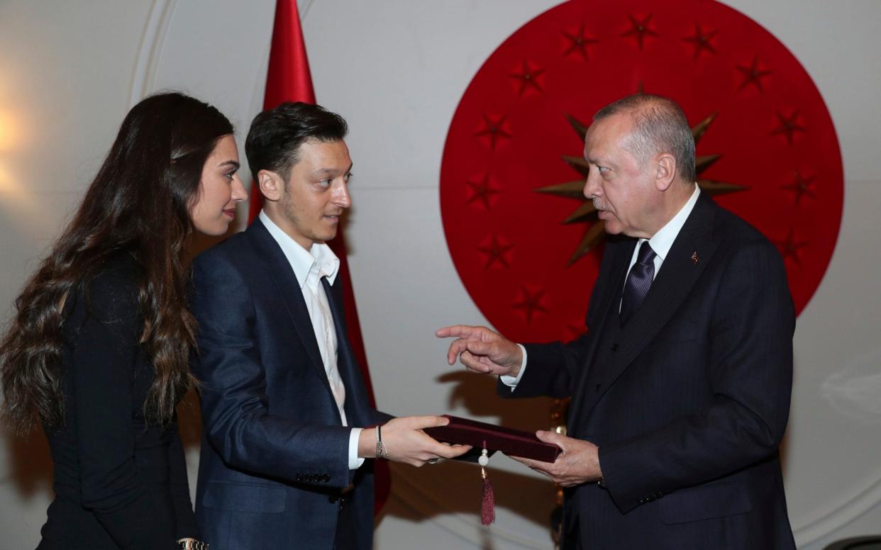 Mr Özil was pictured with his fiancee Amine Gulse meeting Turkey's President Recep Tayyip Erdogan last week - Pool Presidential Press Service