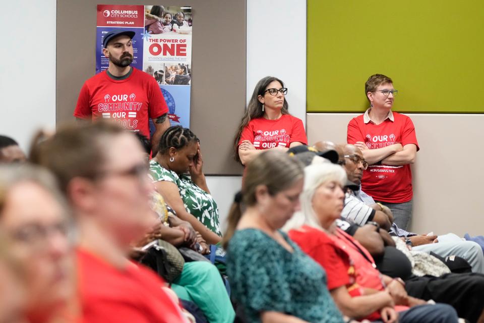 A capacity crowd listens to the preliminary proposal about the potential closing of schools at a Columbus School Board meeting. An overflow room was set up due number of people in attendance.