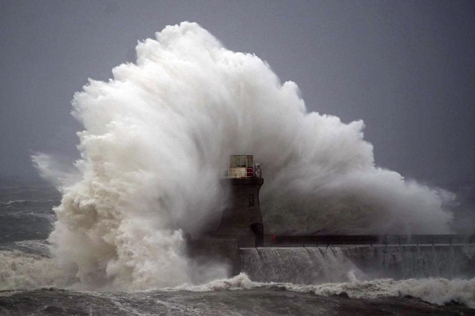 Waves crash against a lighthouse after the top was ripped off, in South Shields, northeastern England, Friday, Oct. 20, 2023. Authorities across northern Europe urged vigilance Friday as the region braced for heavy rain and gale-force winds from the east as a severe storm continued to sweep through. (Owen Humphreys/PA via AP)