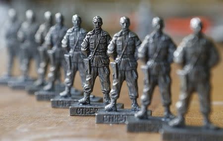 Figurines of former pro-Russian separatist commander Igor Strelkov from the collection entitled "Toy Soldiers of Novorossiya" are on display at a workshop in Moscow August 29, 2014. REUTERS/Sergei Karpukhin