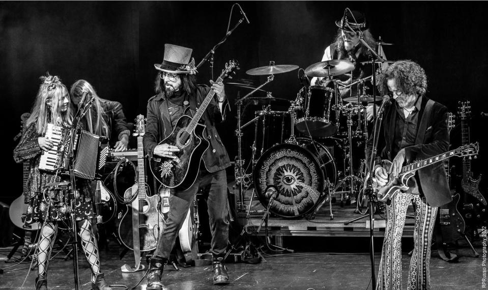 A black-and-white image of the Slambovian Circus of Dreams. From left: Tink Lloyd, RJ McCarty, Joziah Longo, Matthew Abourezk, Sharkey McEwen