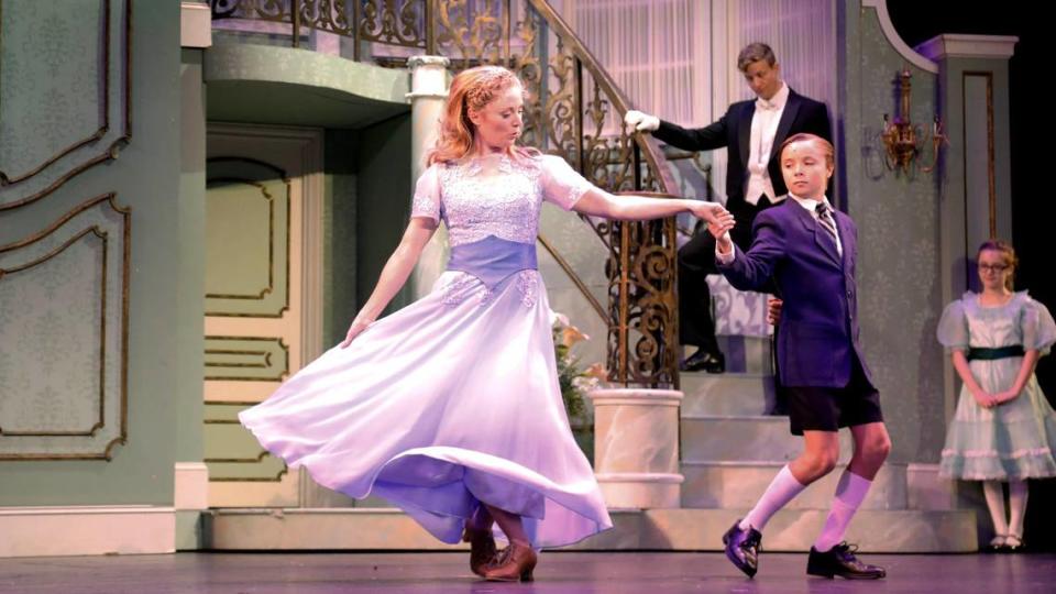 From left, Hayley Podschun, who plays Maria, dances with Reilly Dalton while Jeremy Landon Hays as Captain von Trapp watches. Lexington Theatre Company will present “The Sound of Music” at Lexington Opera House.