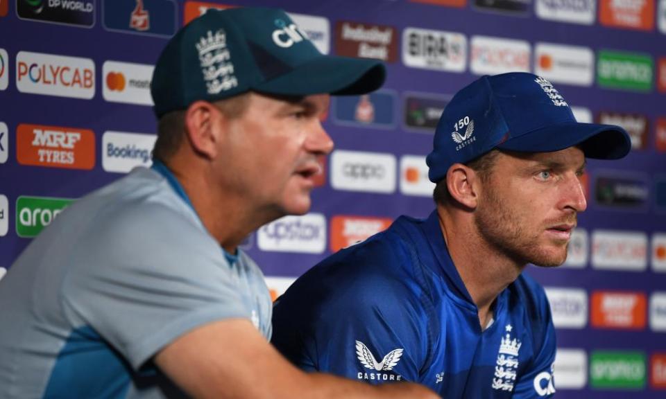 Jos Buttler (right) and Matthew Mott watch from the sidelines.