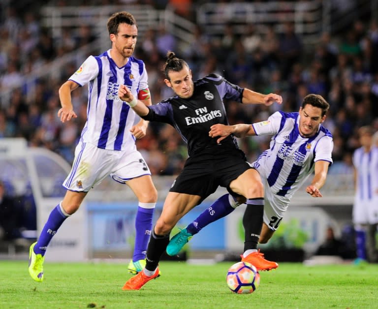 Real Madrid's forward Gareth Bale (C) clashes with Real Sociedad's defender Joseba Zaldua (R) at the Anoeta stadium in San Sebastian on August 21, 2016