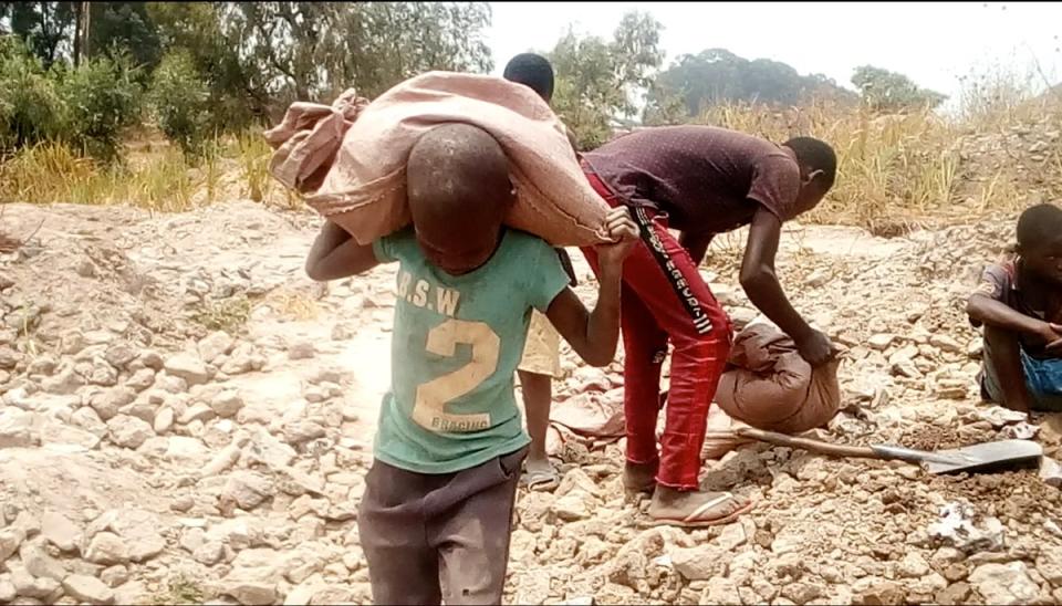 A young boy carries a sack at a small-scale cobalt mining site in the Democratic Republic of the Congo (Siddharth Kara)