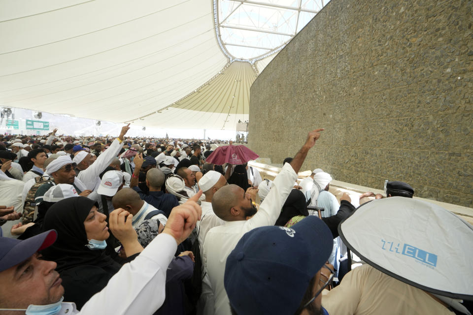 Muslim pilgrims cast stones at pillars in the symbolic stoning of the devil, the last rite of the annual hajj, in Mina, near the holy city of Mecca, Saudi Arabia, Friday, June 30, 2023. (AP Photo/Amr Nabil)