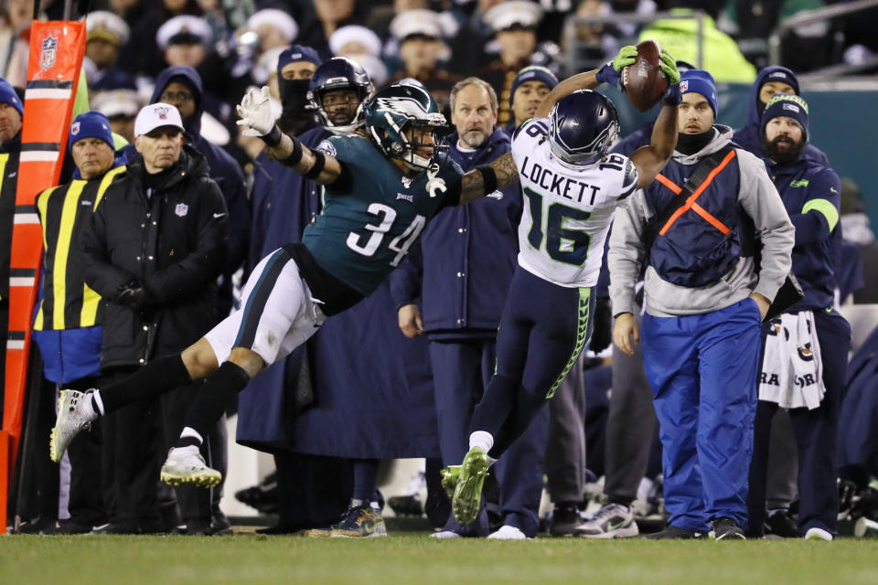 Seattle Seahawks' Tyler Lockett (16) catches a pass against Philadelphia Eagles' Cre'von LeBlanc (34) during the first half of an NFL wild-card playoff football game, Sunday, Jan. 5, 2020, in Philadelphia. (AP Photo/Michael Perez)