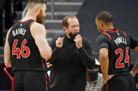 Toronto Raptors head coach Nick Nurse talks to center Aron Baynes (46) and guard Norman Powell (24) during the second half of an NBA basketball game against the Philadelphia 76ers Sunday, Feb. 21, 2021, in Tampa, Fla. (AP Photo/Chris O'Meara)